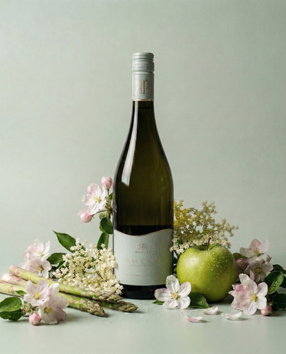 Bottle of white wine with green apple and asparagus on a light background