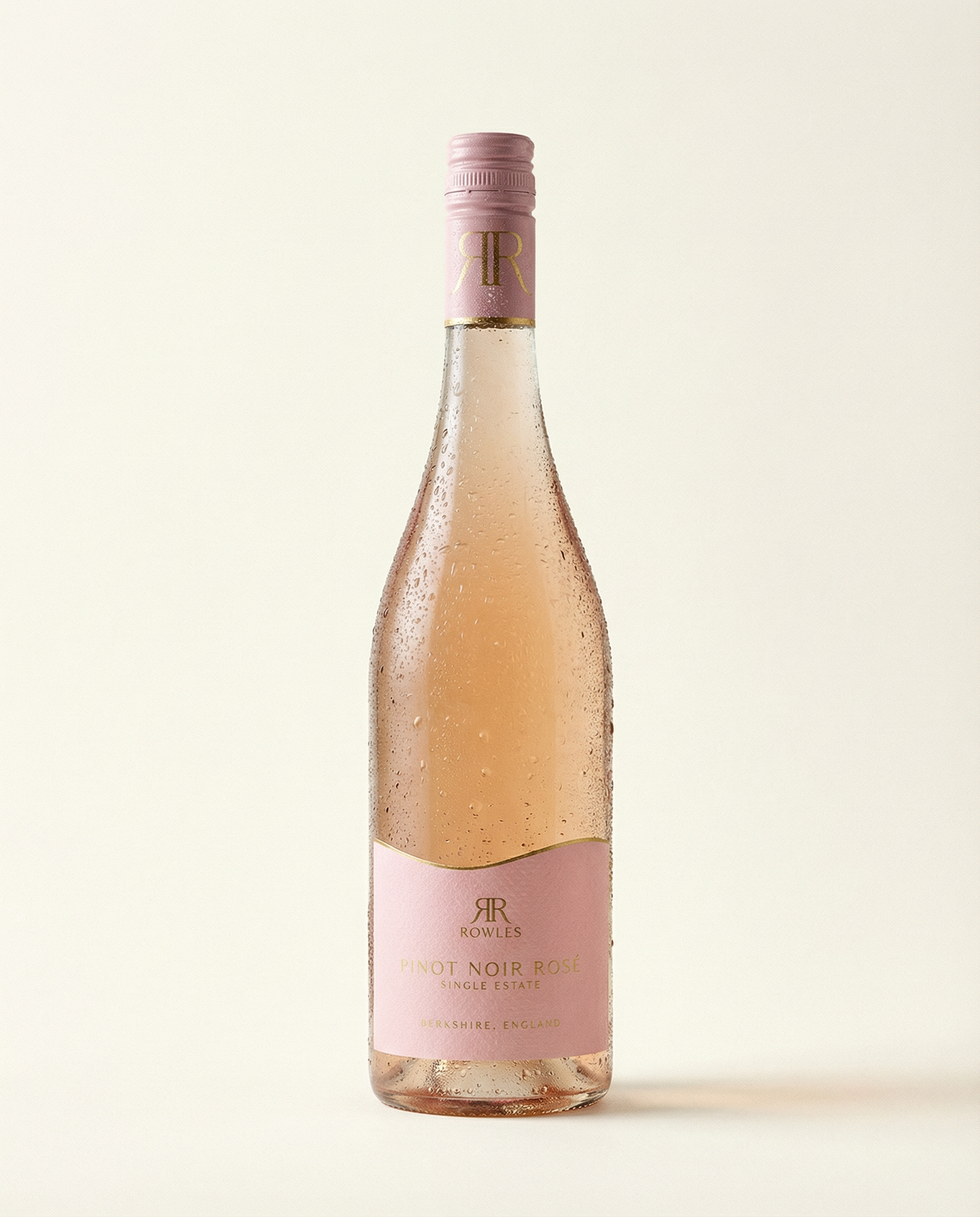 Bottle of rose wine with a pink label on a light background