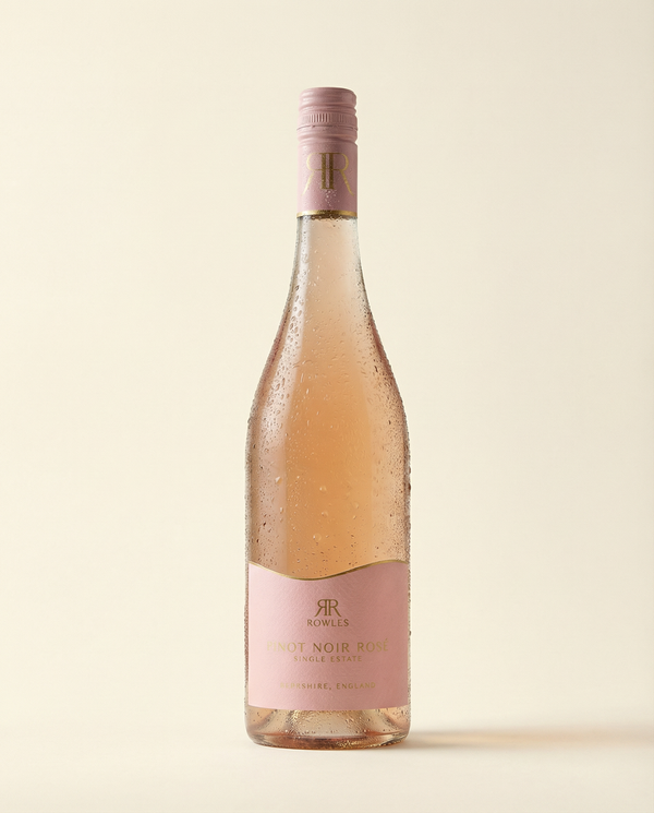 Bottle of Rosé wine with a pink label on a beige background